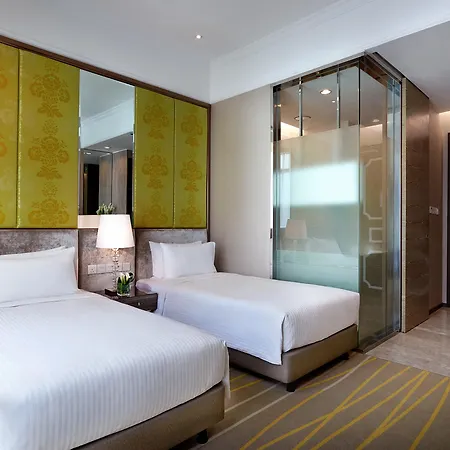 Dorsett Putrajaya Hotel Bagian luar foto The photo shows a modern hotel room with two twin beds dressed in white linens. There are stylish headboards behind each bed, complemented by vibrant yellow panels on the wall. A glass partition is visible, likely leading to a bathroom area, which ad